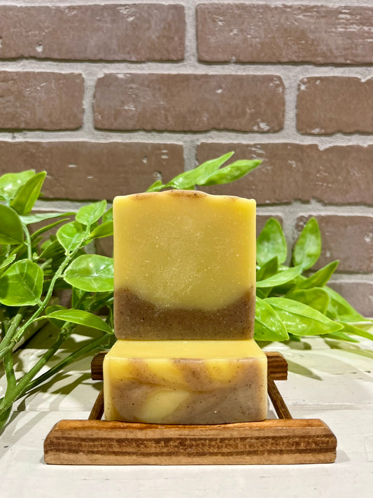 Citrus woods soap bars in front of brick wall