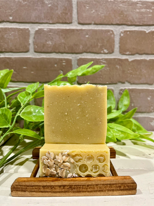 Oatmeal honey soap bars in front of brick wall