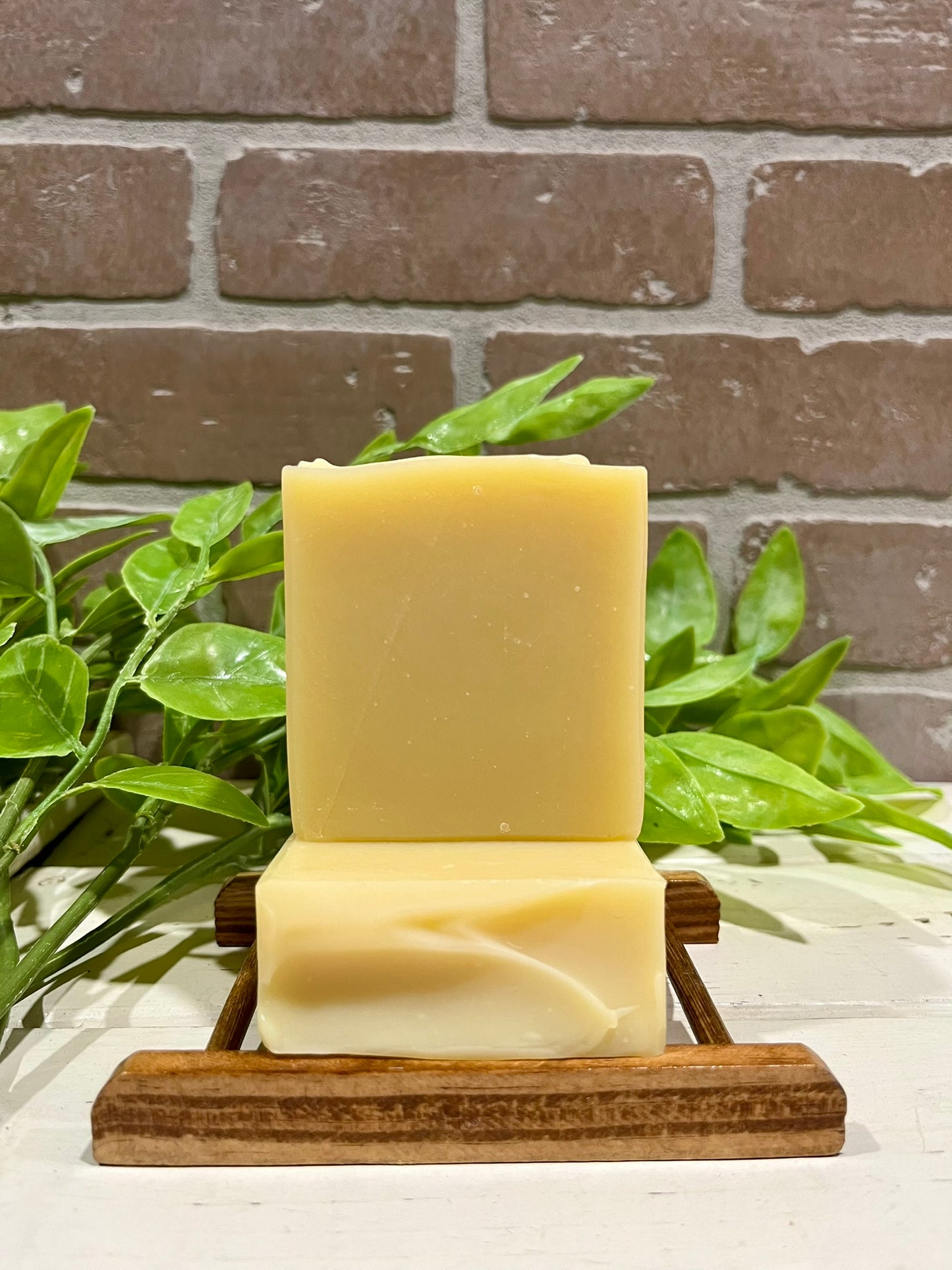 Triple butter soap bars in front of brick wall