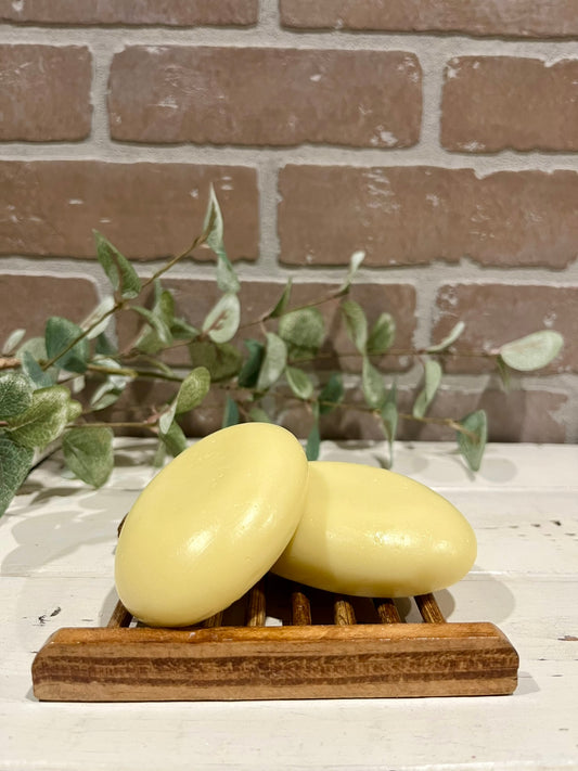 oval hair soap bars in front of brick wall