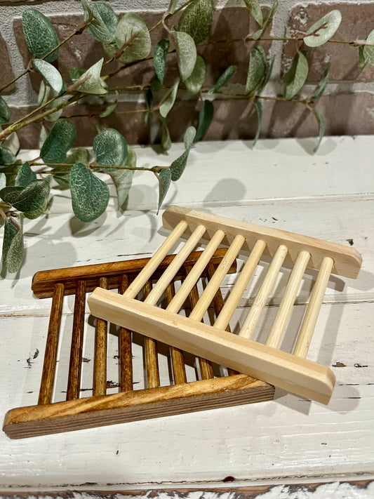 wooden soap dishes in front of brick wall